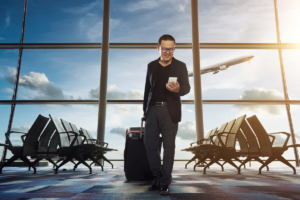 A person looking at technology in an airport - Airport Lighting Company