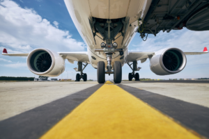 The underside of an airplane showing airport control systems - Airport Lighting Company